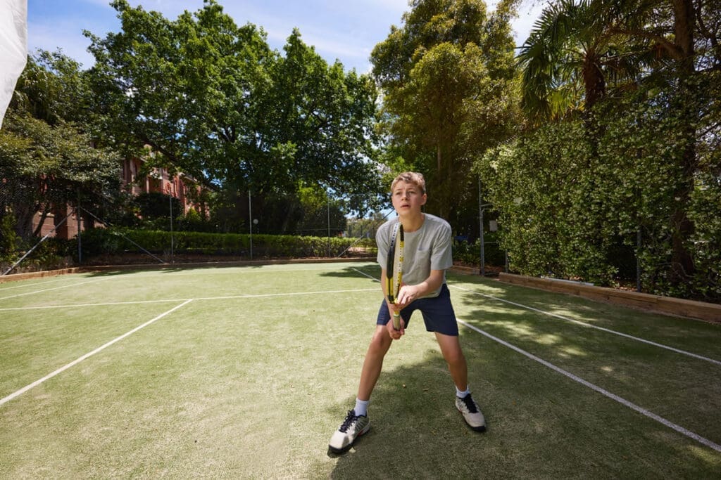 Young person playing tennis