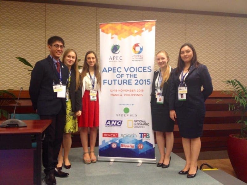 Attendees at APEC Youth Forum standing either side of banner