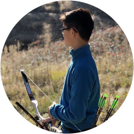 Young person holding an archery bow