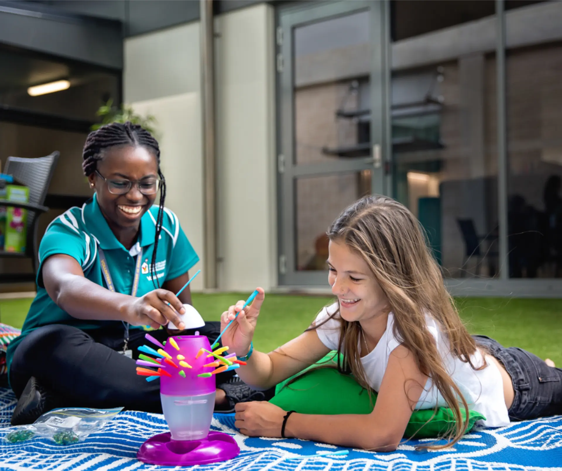 Two girls playing a stick game