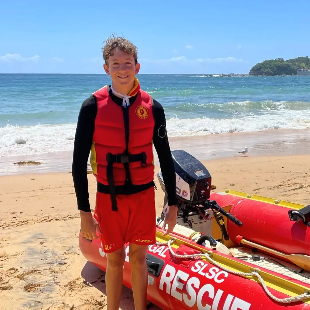 Young Surf Life Saver standing on beach